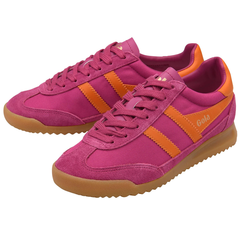 Pink Gola trainers with orange stripes and gum sole on a white background