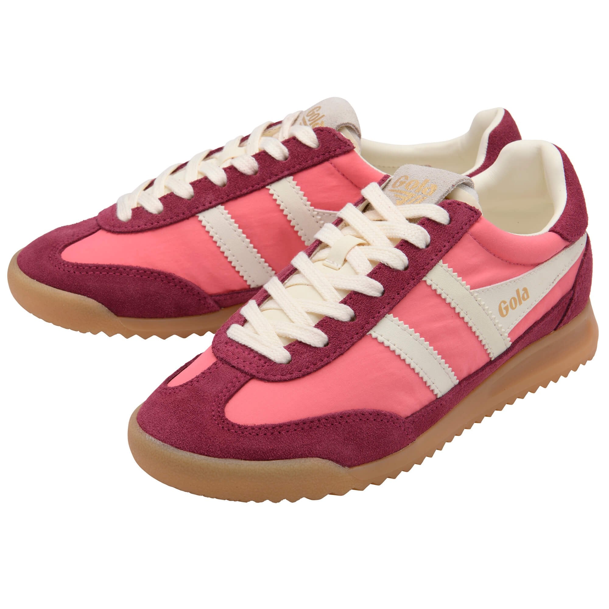 Pink and maroon Gola trainers with white laces and gum sole on a white background