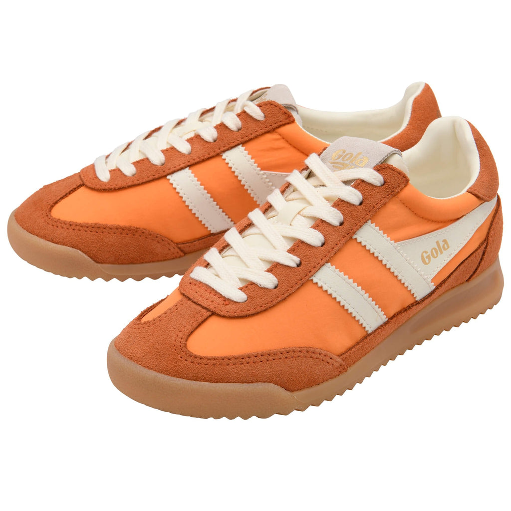 Orange Gola trainers with white stripes on a white background
