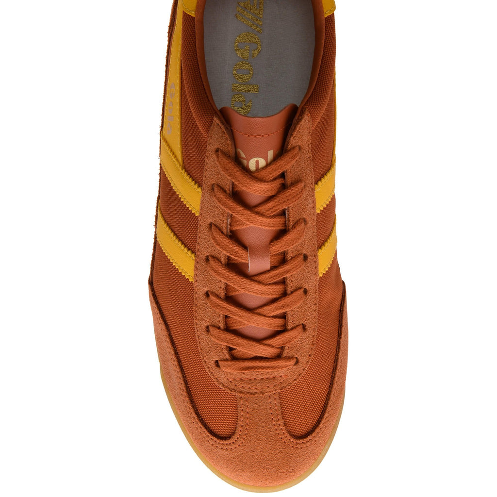 Orange trainer with yellow stripes on a white background