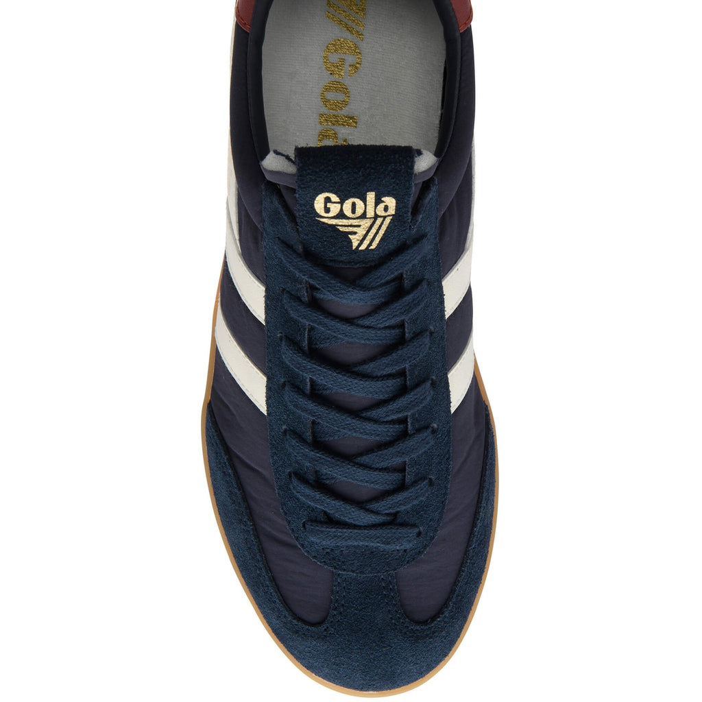 Navy blue Gola trainer with white stripes on a white background