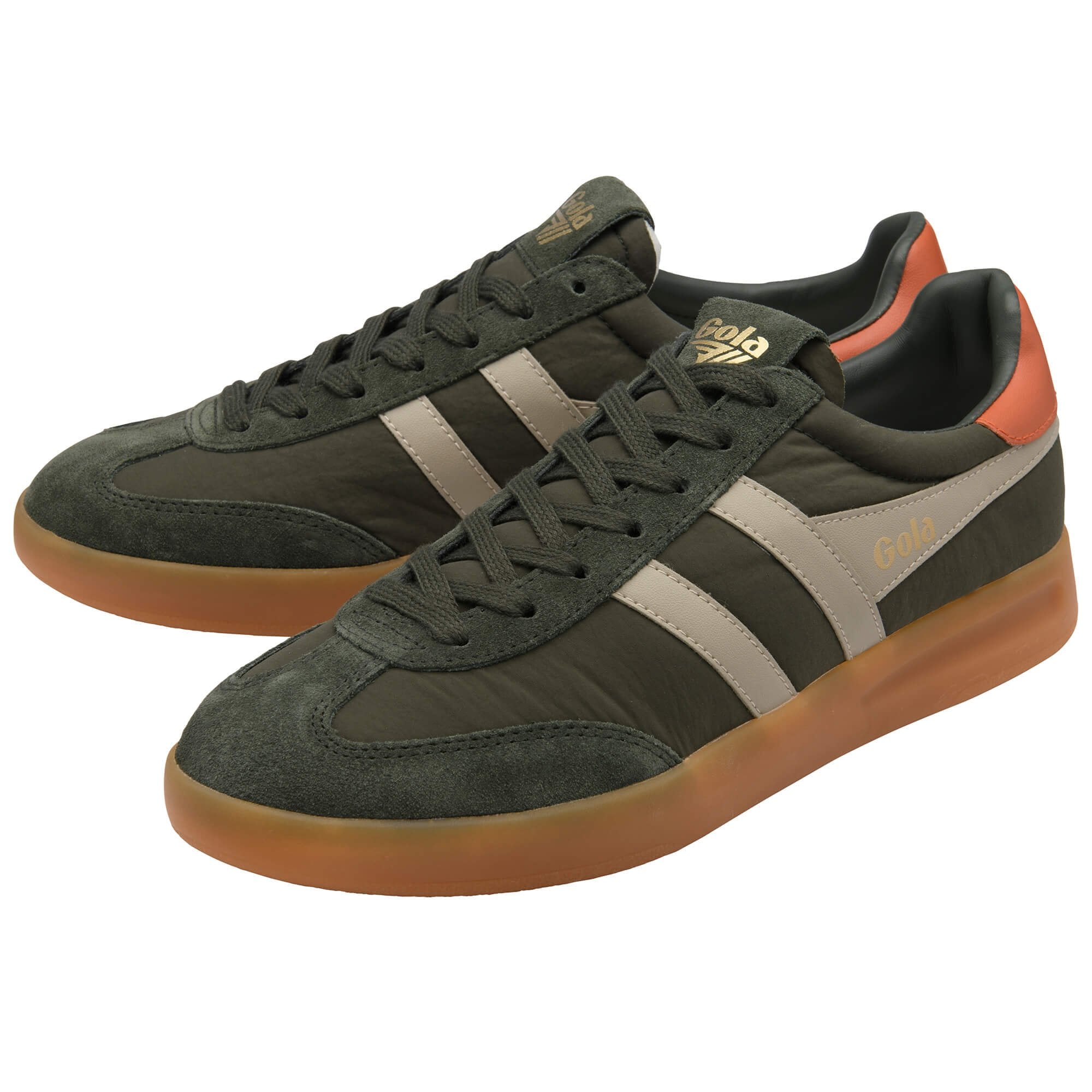 Green trainers with brown soles on a white background