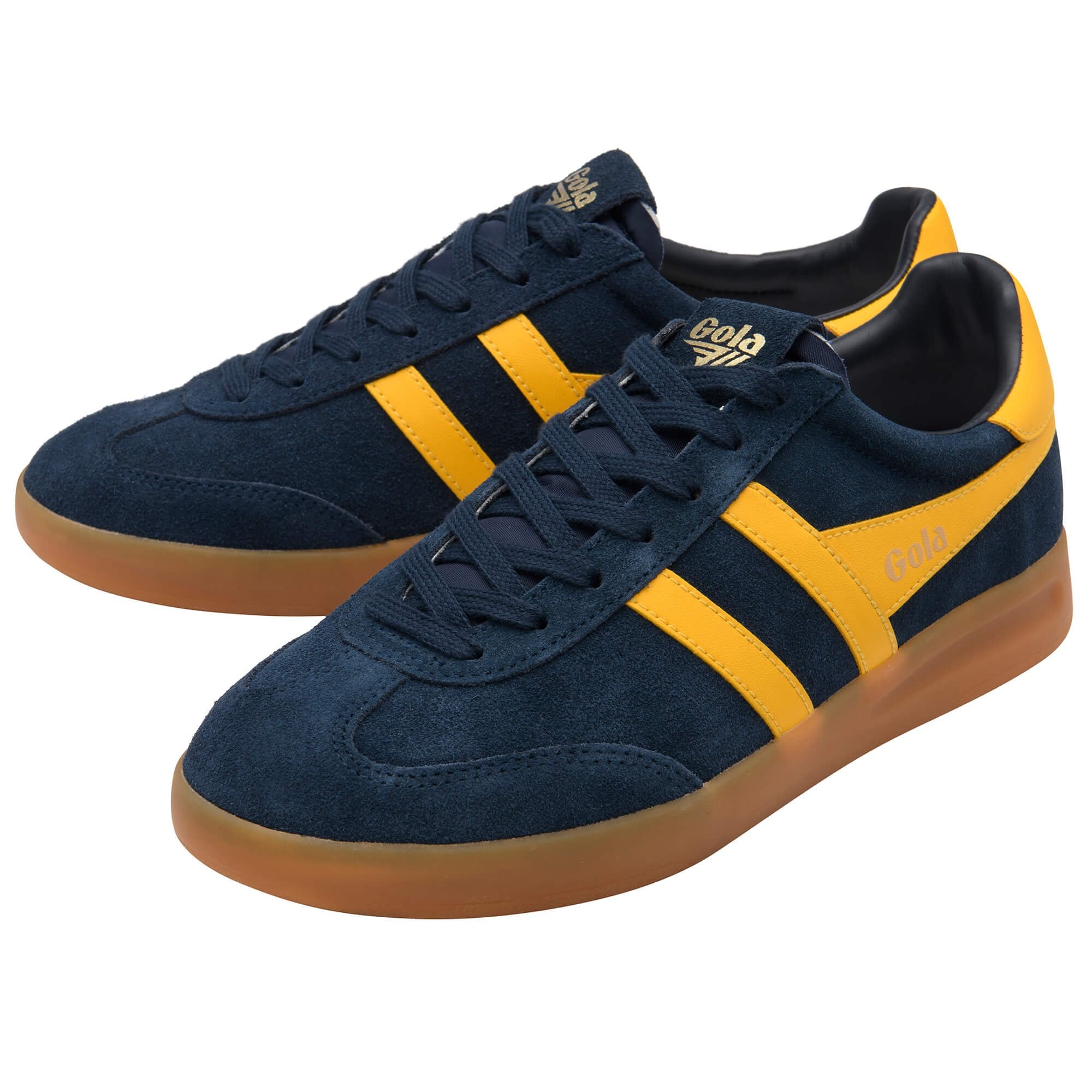 Navy blue and yellow trainers with brown soles on a white background