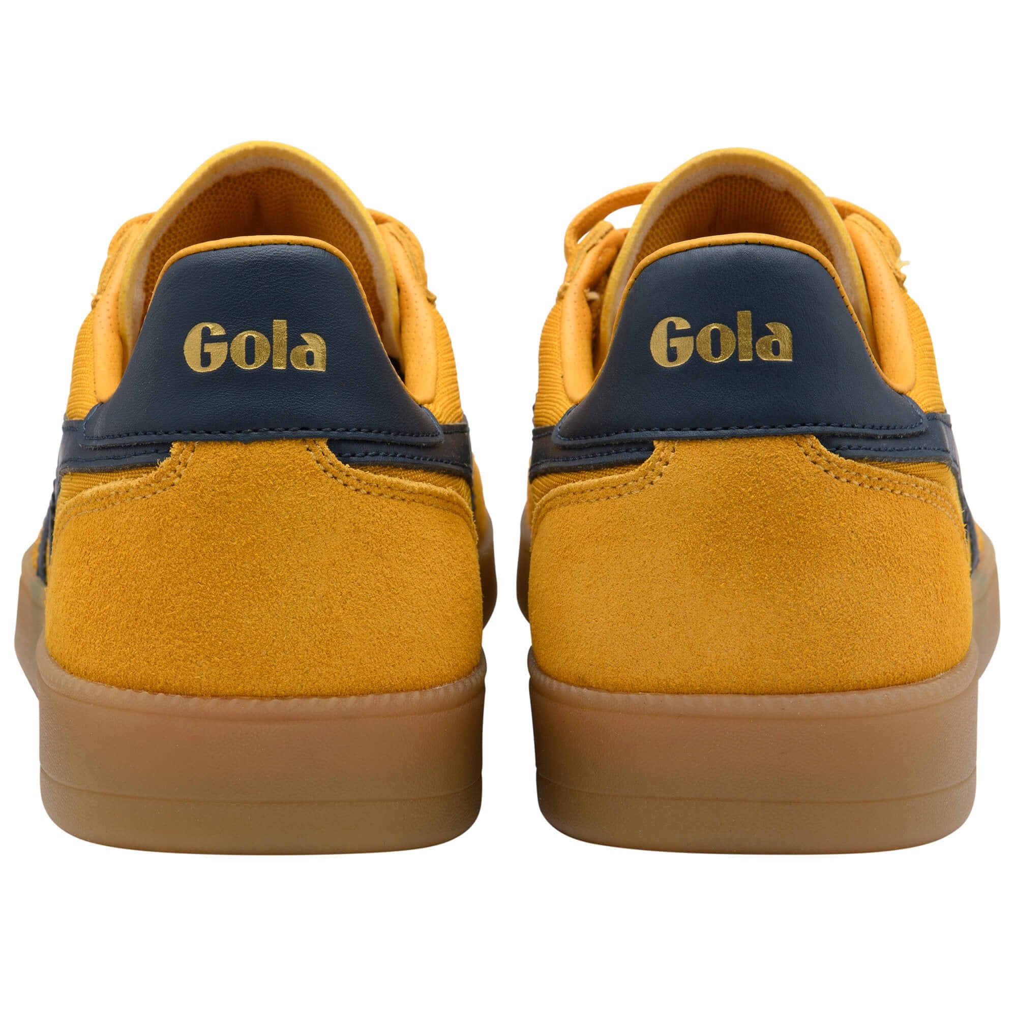 Yellow Gola trainers with brown soles on a white background