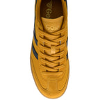 Yellow trainer with black accents on a white background