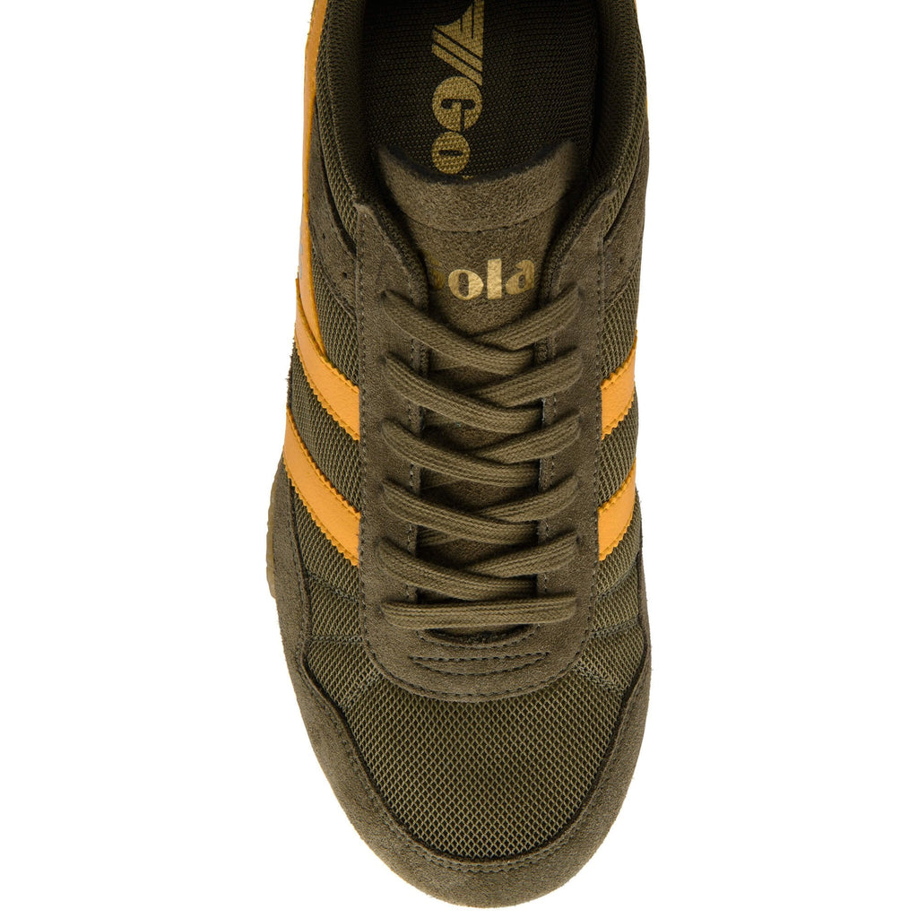 Green trainer with yellow stripes on a white background