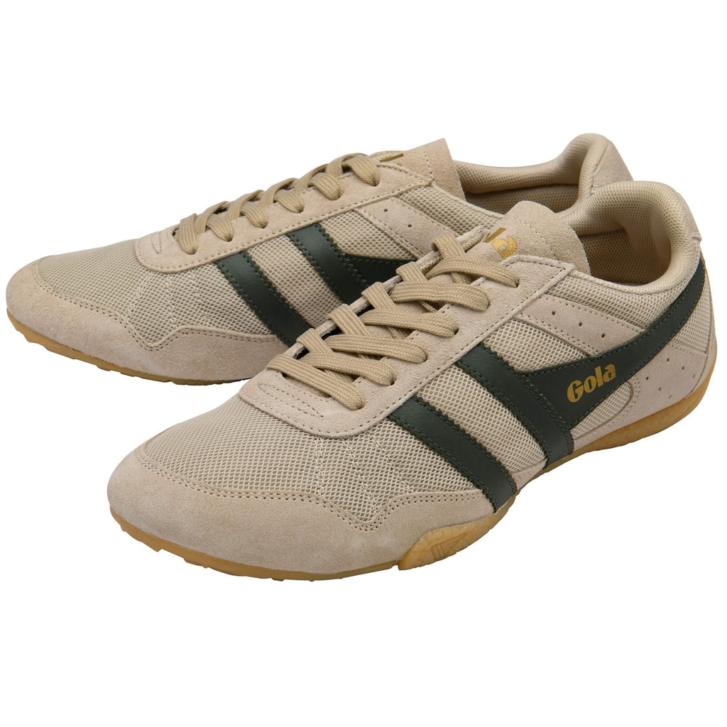Beige trainers with black stripes and 'Gola' branding on a white background