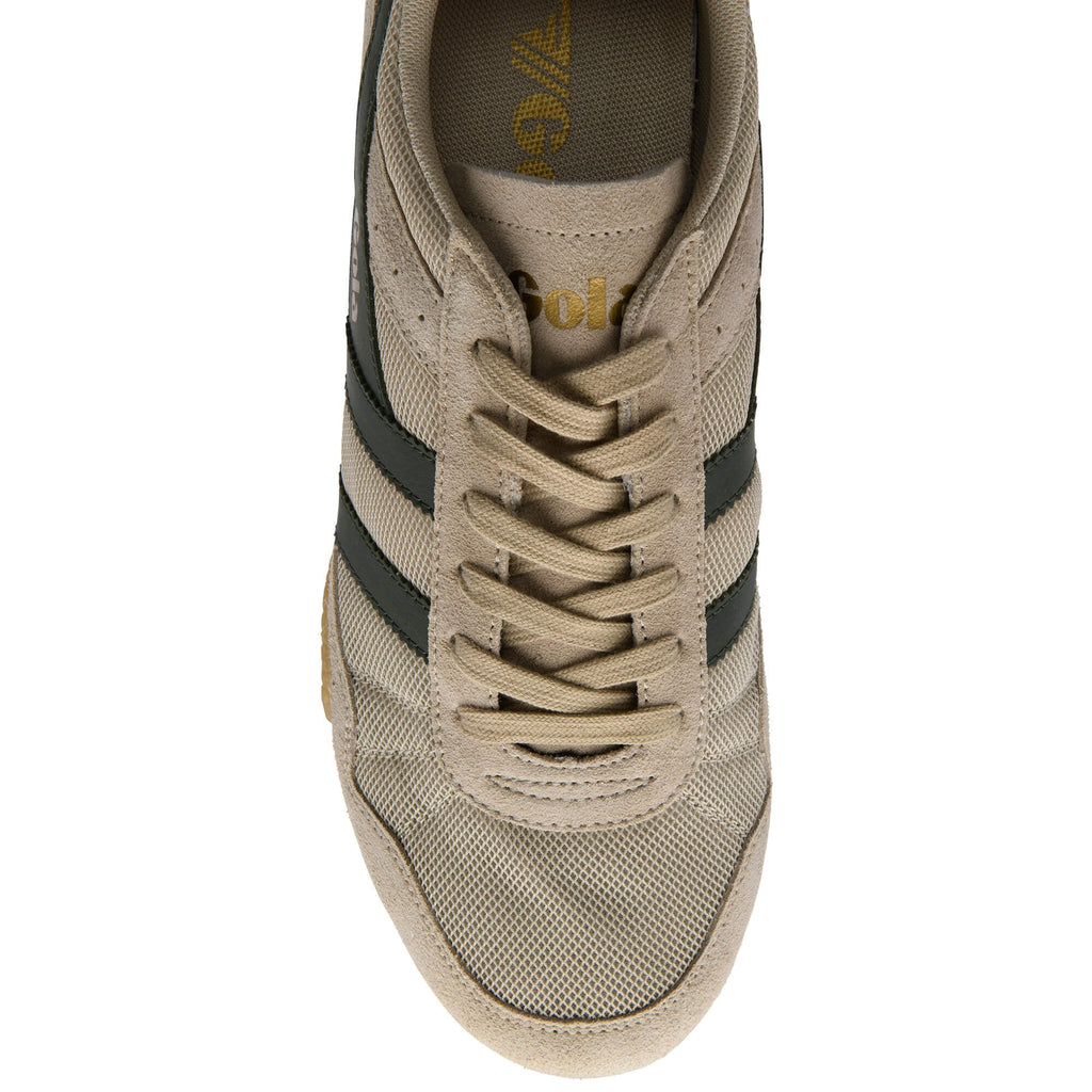 Beige trainer with black stripes on a white background