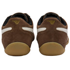 Pair of brown suede shoes with white stripes and a gold logo on the heel
