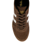 Brown trainer with white stripes on a white background