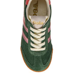 Top down view of a green suede Gola trainer with pink stripes and white laces on a white background
