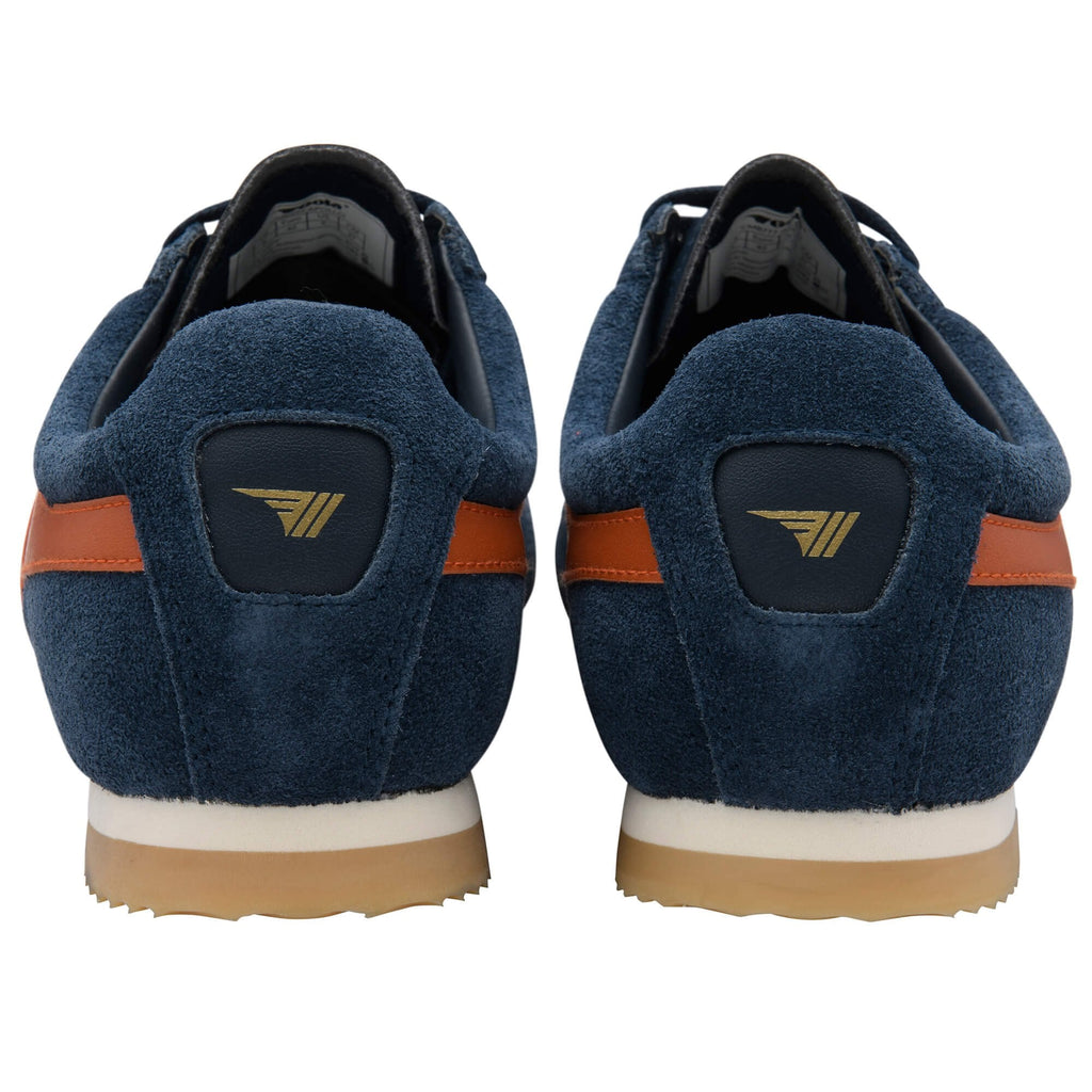 Pair of blue trainers with orange accents on a white background