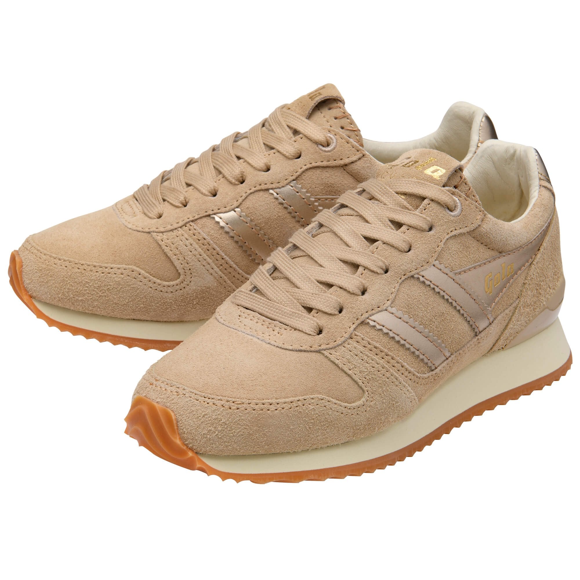 Beige trainers with brown soles on a white background