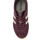 Top-down view of a single Gola Harrier trainer in burgundy suede with white stripes and laces