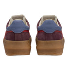 Rear view of two burgundy suede trainers with blue leather heel tabs and tan rubber soles