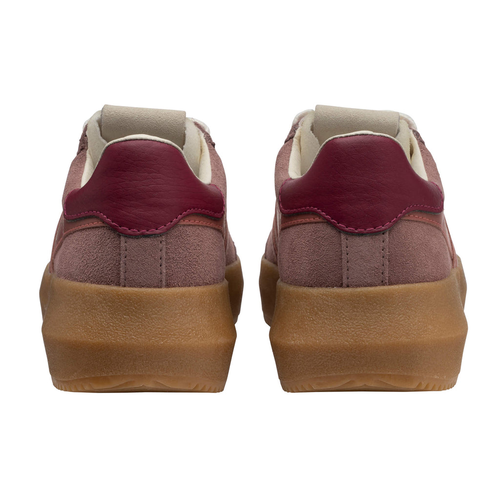 Pair of pink suede trainers with burgundy heel tabs and tan rubber soles, rear view