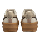 Pair of white and gold trainers with brown soles, rear view