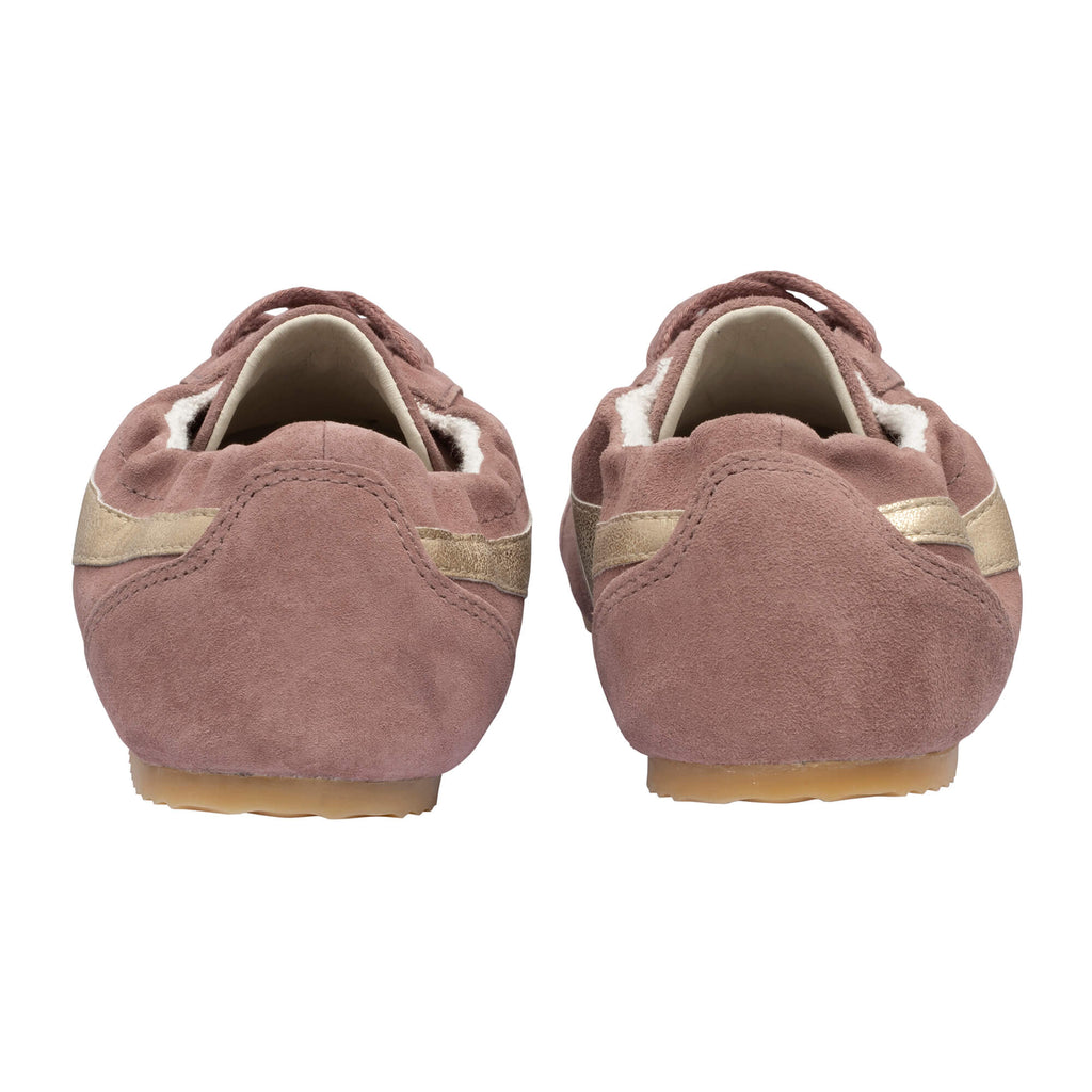 Pair of pink suede ballet slippers with gold stripes, seen from behind