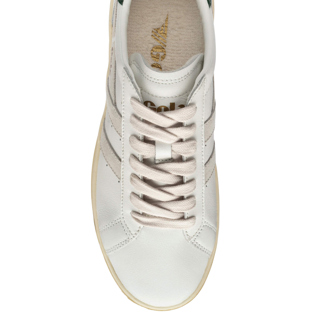 Top down view of a white trainer with beige laces and a beige sole