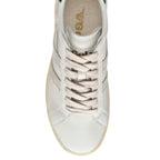 Top down view of a white trainer with beige laces and a beige sole