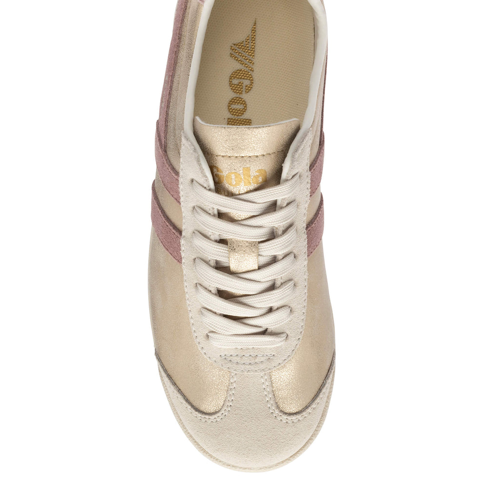 Top-down view of a gold and pink Gola trainer