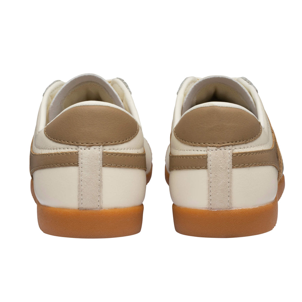 Rear view of two cream trainers with brown heel tabs and gum soles