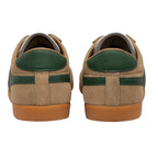 Pair of beige suede trainers with green heel and stripe details, brown rubber soles, rear view
