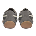 Rear view of two grey suede and mesh trainers with light brown soles