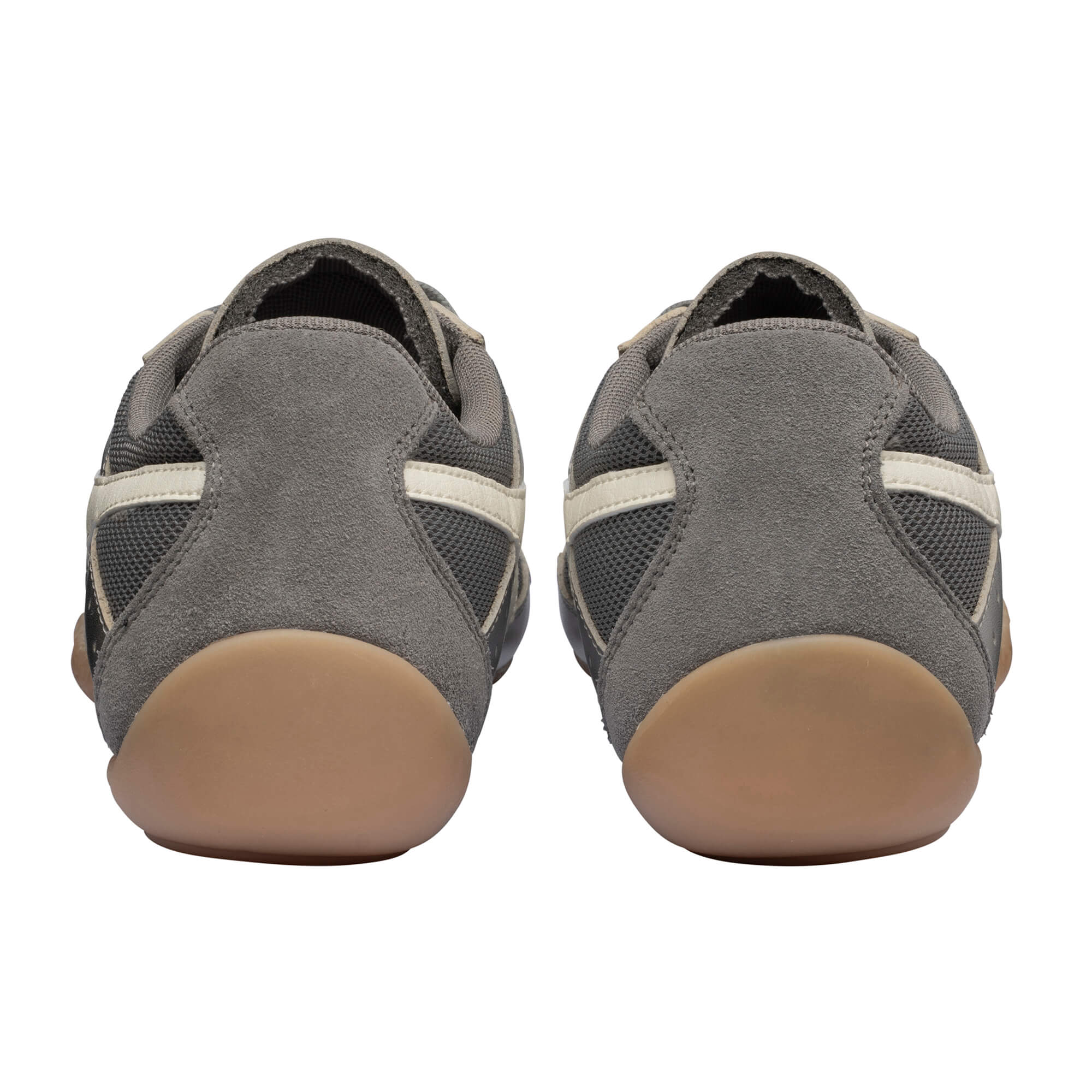 Rear view of two grey suede and mesh trainers with light brown soles