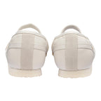 Rear view of two white leather and suede trainers with cream soles