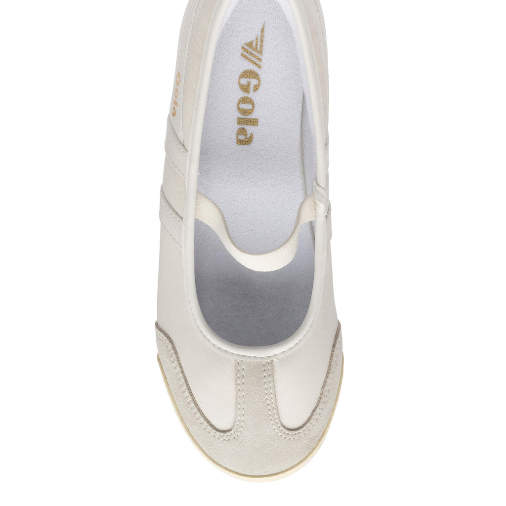 Top down view of a cream Gola Harrier trainer with a gold Gola logo on the insole