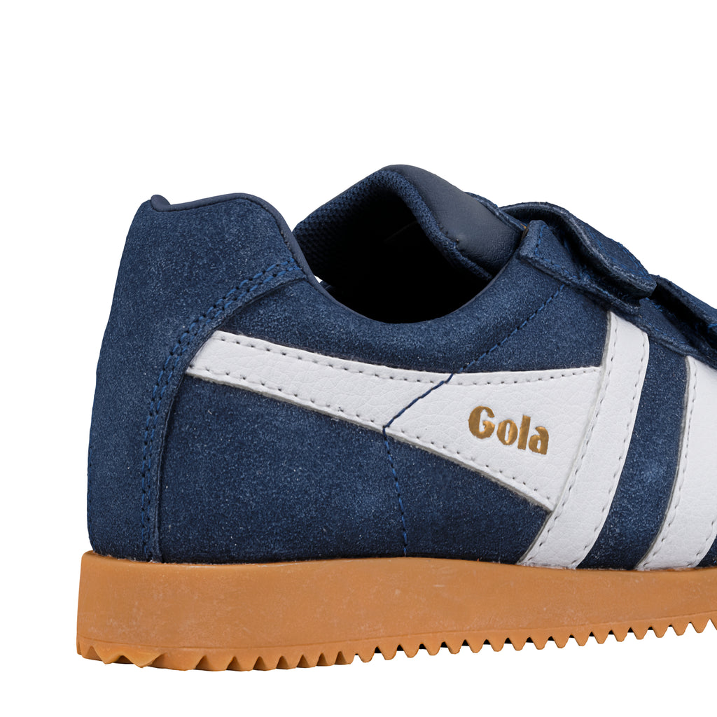 Close up of blue suede Gola trainer with white side stripe and gum sole