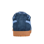 Rear view of a navy blue suede trainer with a gum rubber sole