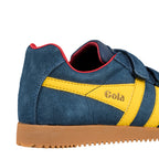 Close up of blue suede trainer with yellow side stripes and gum sole