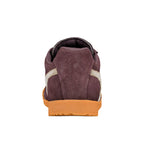 Rear view of a burgundy suede trainer with a gum rubber sole