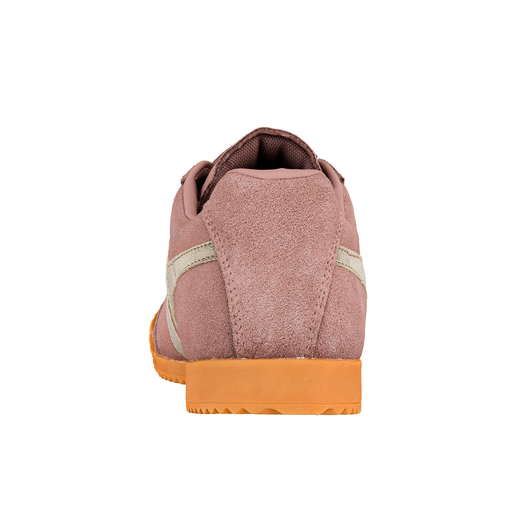 Rear view of a mauve suede trainer with a gum rubber sole