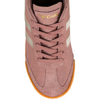 Top view of a dusty pink suede Gola Harrier trainer with gold side stripes and a gum rubber sole