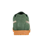 Rear view of a green suede trainer with a gum rubber sole