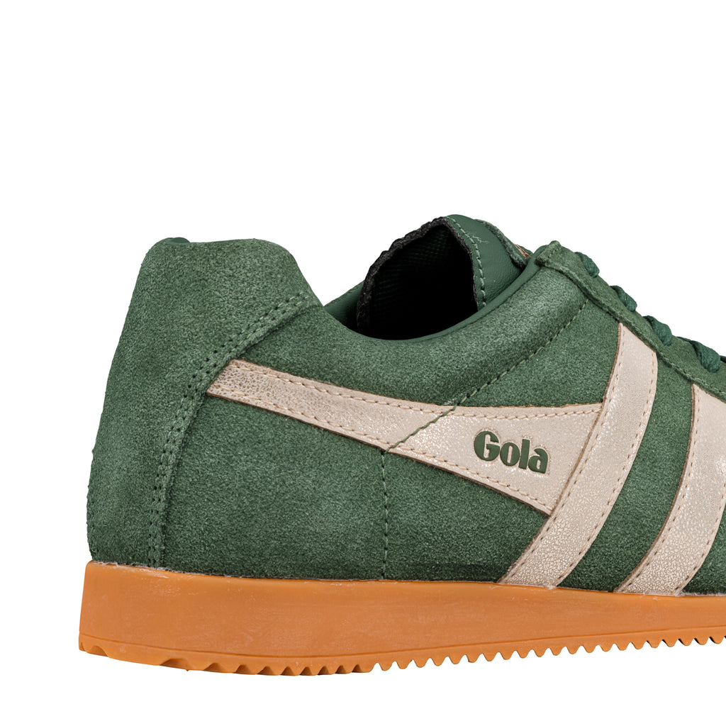 Close up of green suede Gola trainer with cream side stripes and gum sole