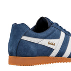 Close-up of a Gola trainer in blue suede with white stripes and a brown sole