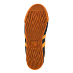 Rubber sole of a navy and orange Gola trainer with a chevron tread pattern