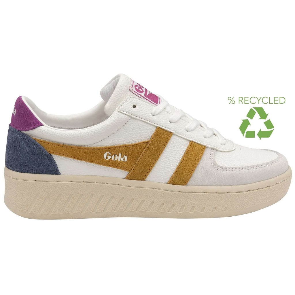 White Gola trainer with gold stripes, purple heel, and blue suede accent, with a green recycled logo on a white background