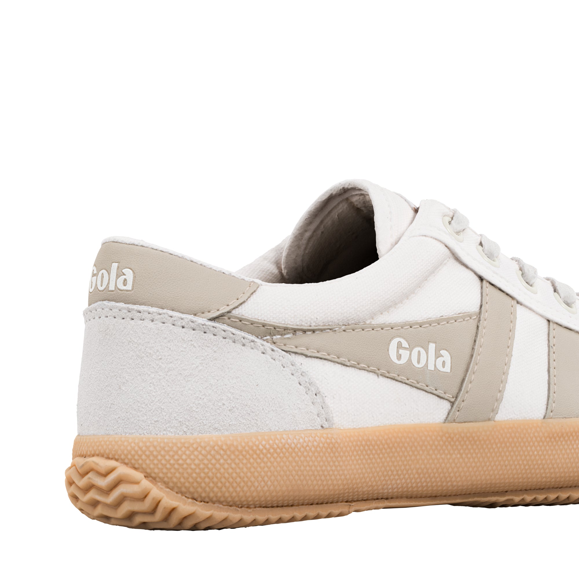 Close up of the heel and side of a white canvas Gola trainer with beige suede detailing and a gum rubber sole