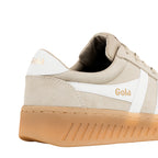 Close up of the heel and side of a beige suede Gola trainer with a gum sole