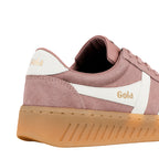 Close up of the heel and side of a pink suede Gola trainer with a white stripe and gum sole