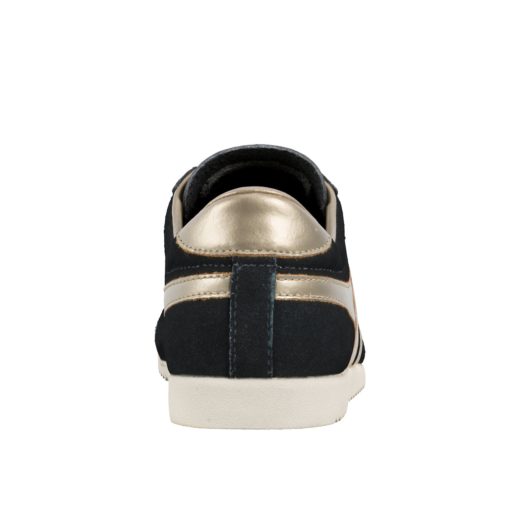 Rear view of a black suede trainer with metallic gold heel detail and white rubber sole