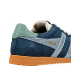 Rear view of a navy blue suede trainer with a green heel tab and gum sole