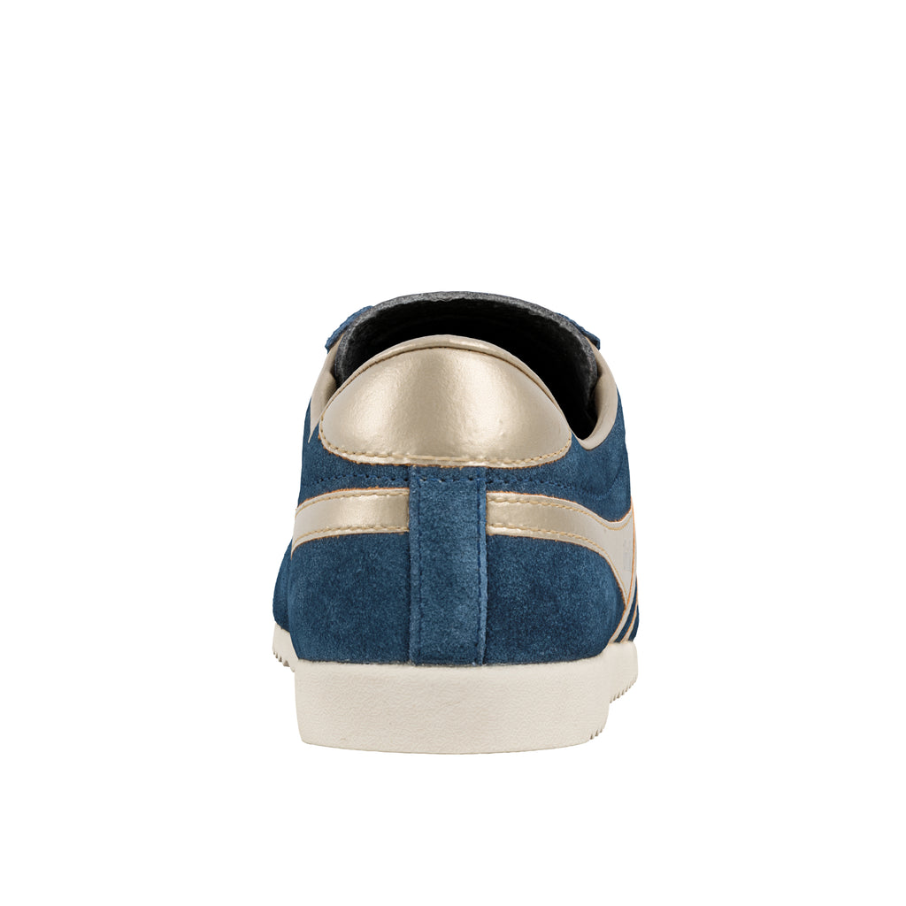 Rear view of a blue suede trainer with metallic gold heel tab and white rubber sole