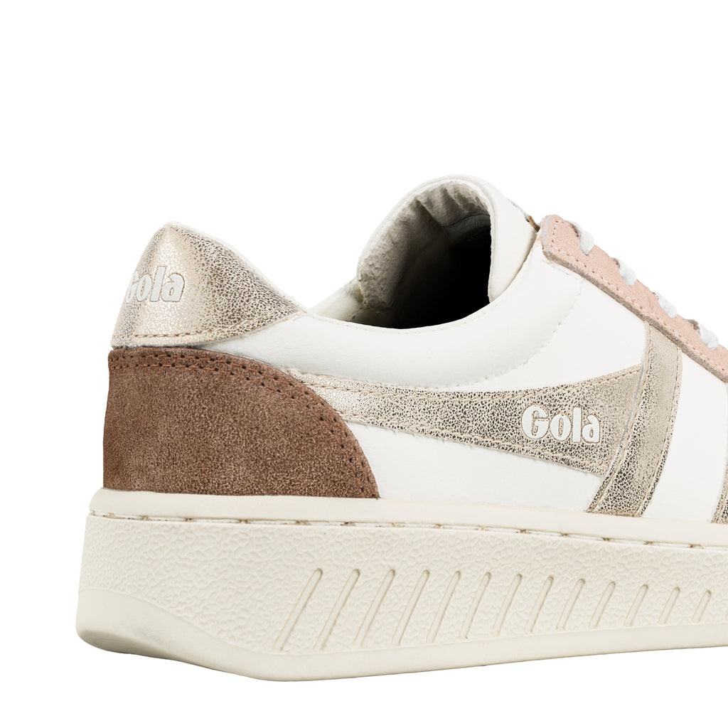 Close up of the heel and side of a white Gola trainer with metallic gold and brown suede detailing