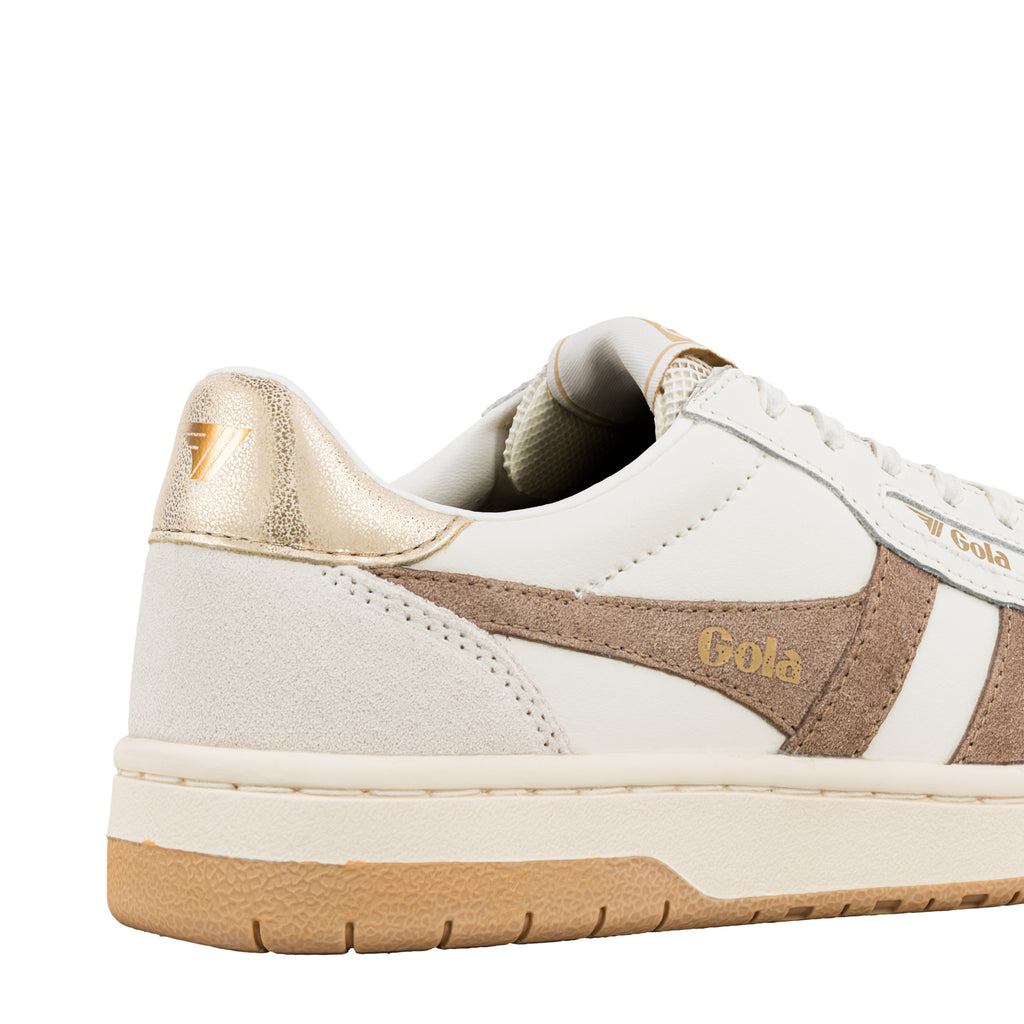 Close up of a white Gola trainer with metallic gold heel tab and beige suede side panel